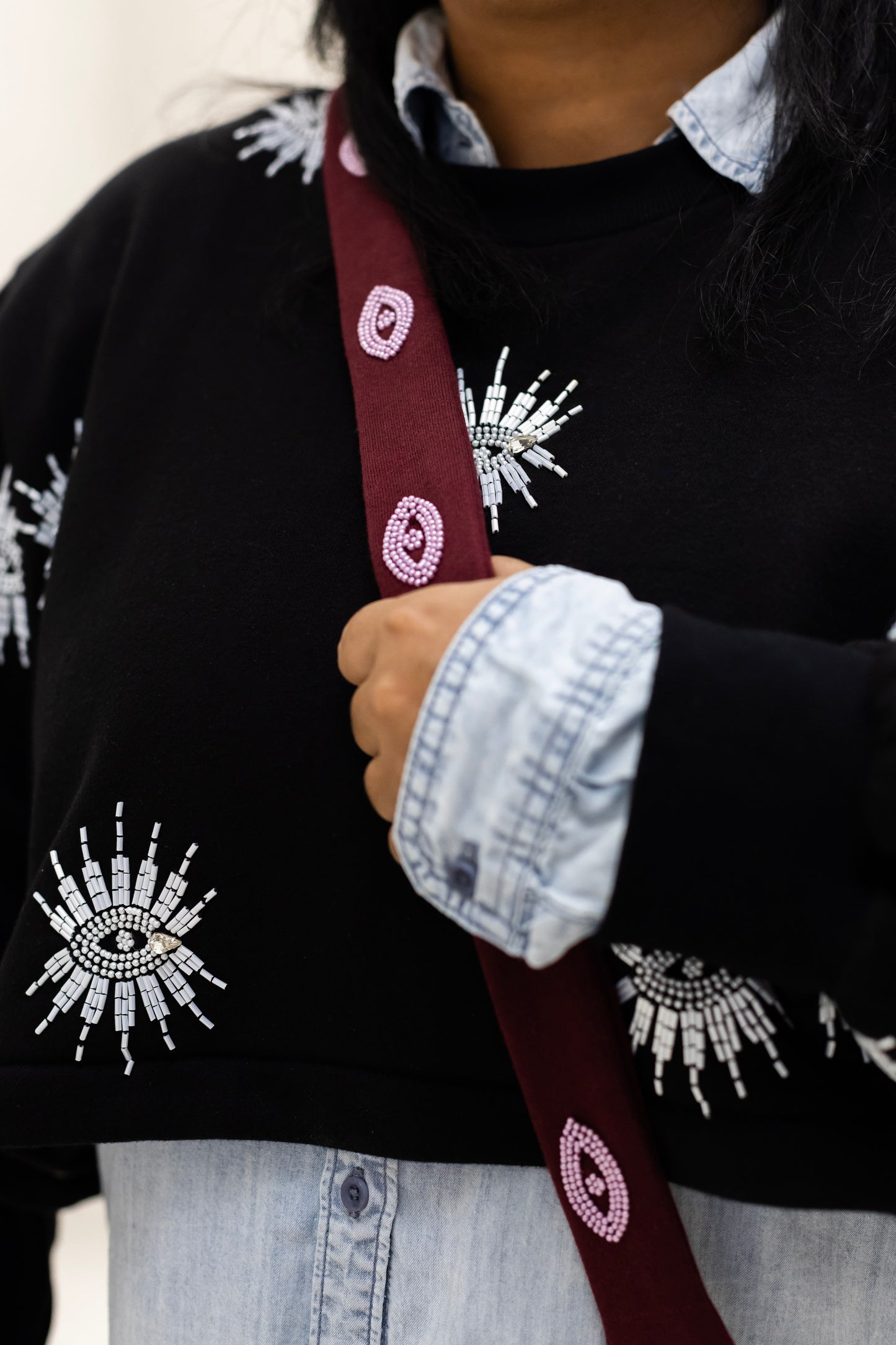 Sustainably and ethically handcrafted burgundy purse dress with a beaded eye pattern.