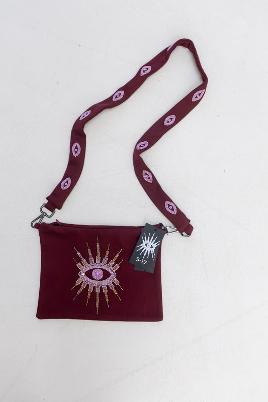 Sustainably and ethically handcrafted burgundy purse dress with a beaded eye pattern.