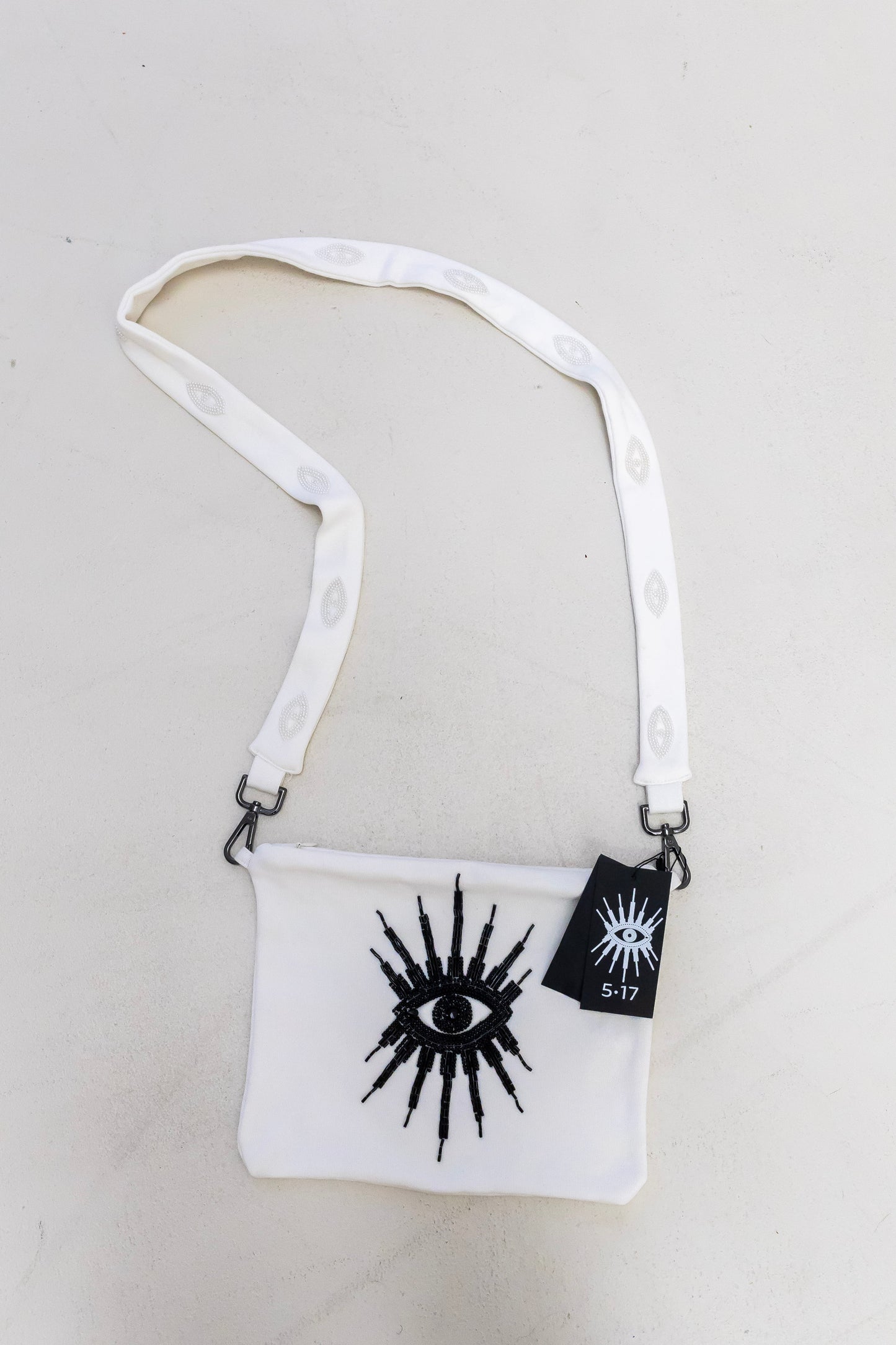 Sustainably and ethically handcrafted white purse dress with a beaded eye pattern.