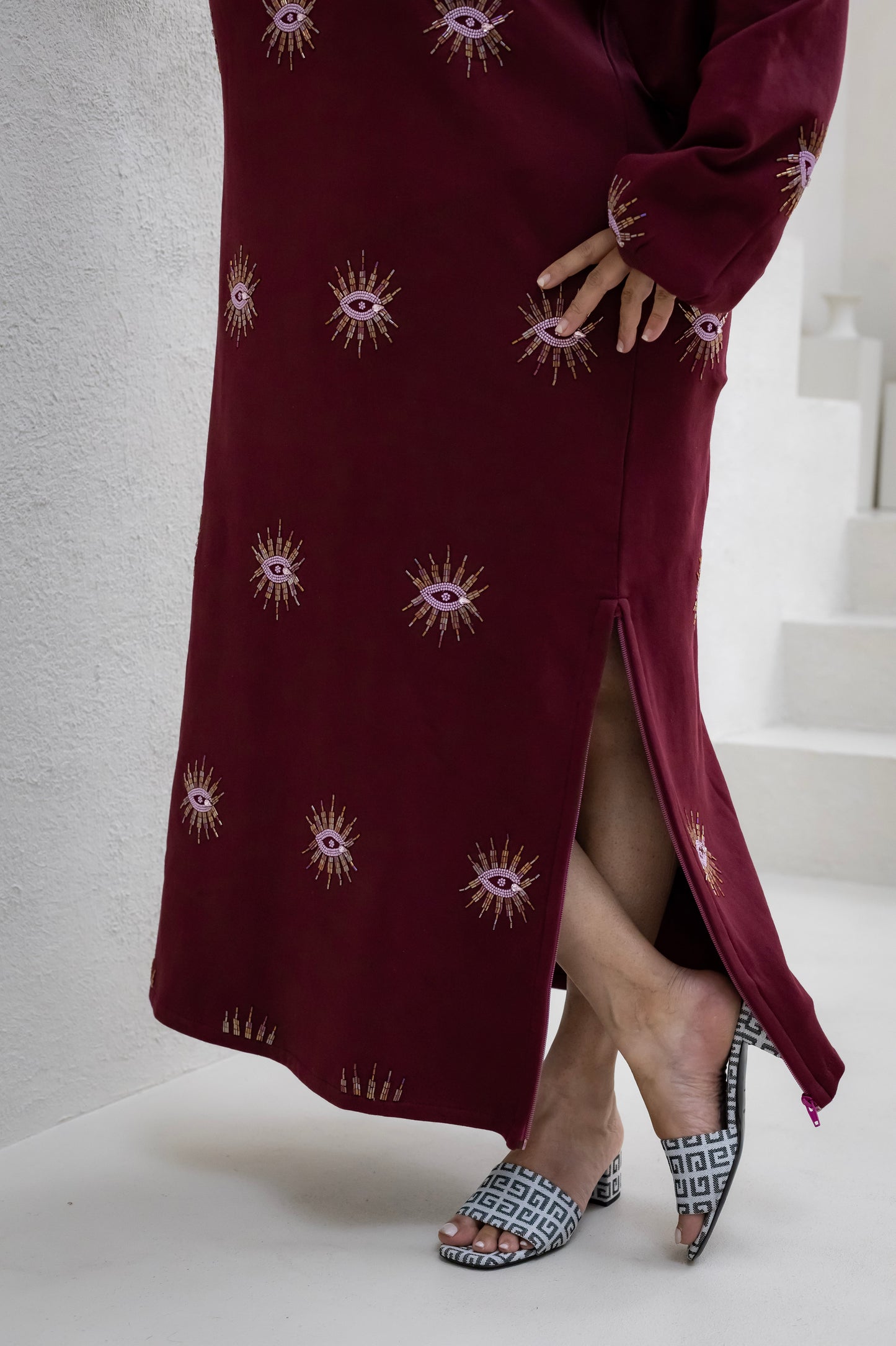 Sustainably and ethically handcrafted burgundy sweatshirt dress with a beaded eye pattern.