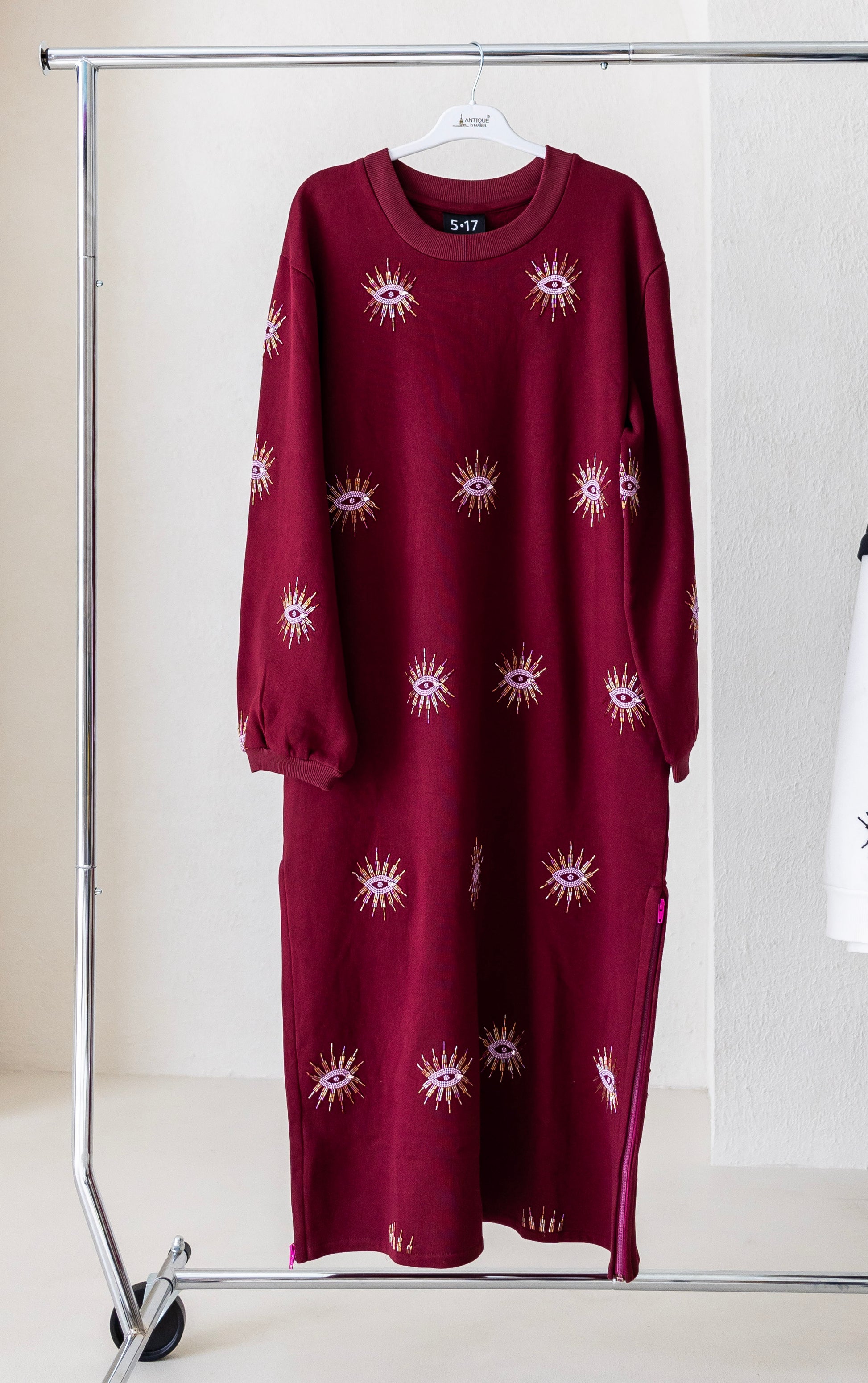 Sustainably and ethically handcrafted burgundy sweatshirt dress with a beaded eye pattern.